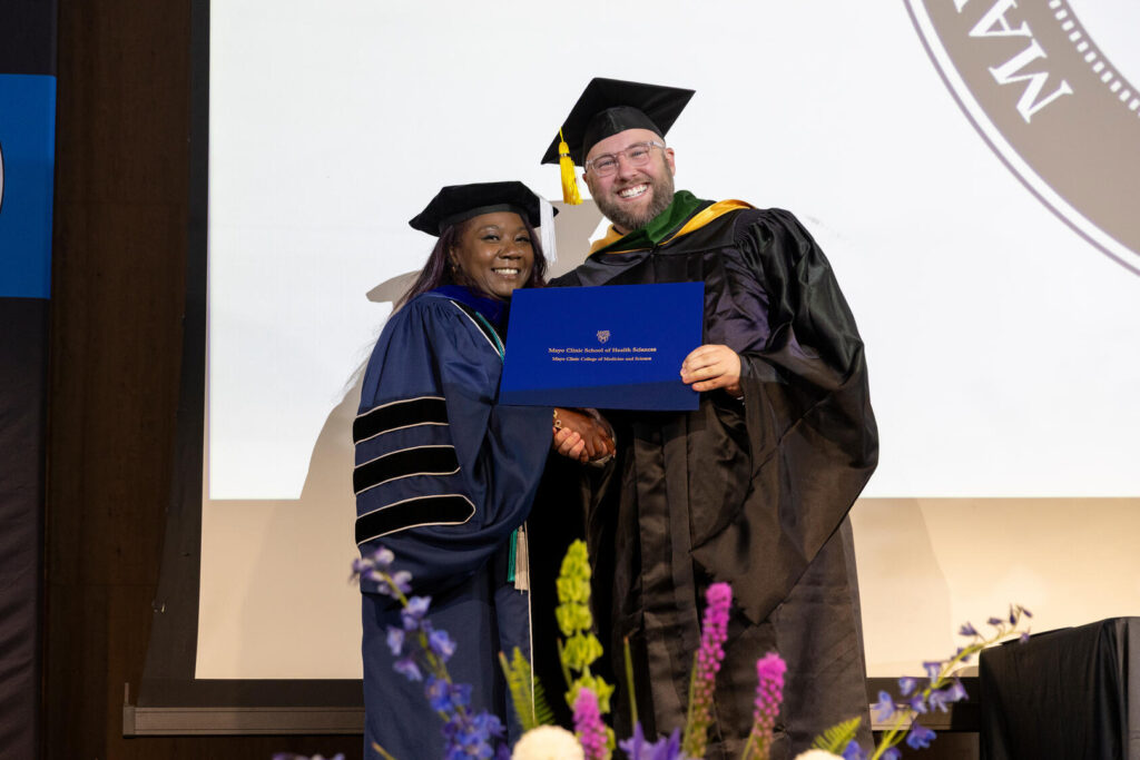Physician Assistant Program graduation, 2025 - Brandon Trammell, Physician Assistant Program graduate, on stage during the Mayo Clinic Physician Assistant Program graduation, 2025. Asset requested to commemorate and celebrate the Physician Assistant graduates.