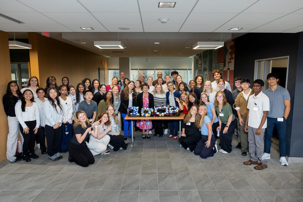 Students and program staff pose for a photo with cupcakes spelling out "10th CIP" during the Mayo Clinic School of Health Sciences (MCSHS) Career Immersion Program.